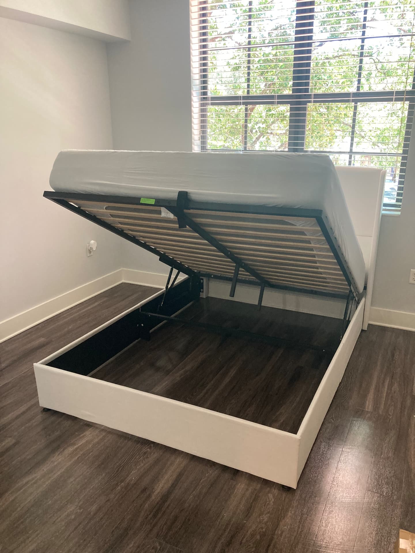 Gas-lift storage bed base opened showing hydraulic mechanism after assembly service