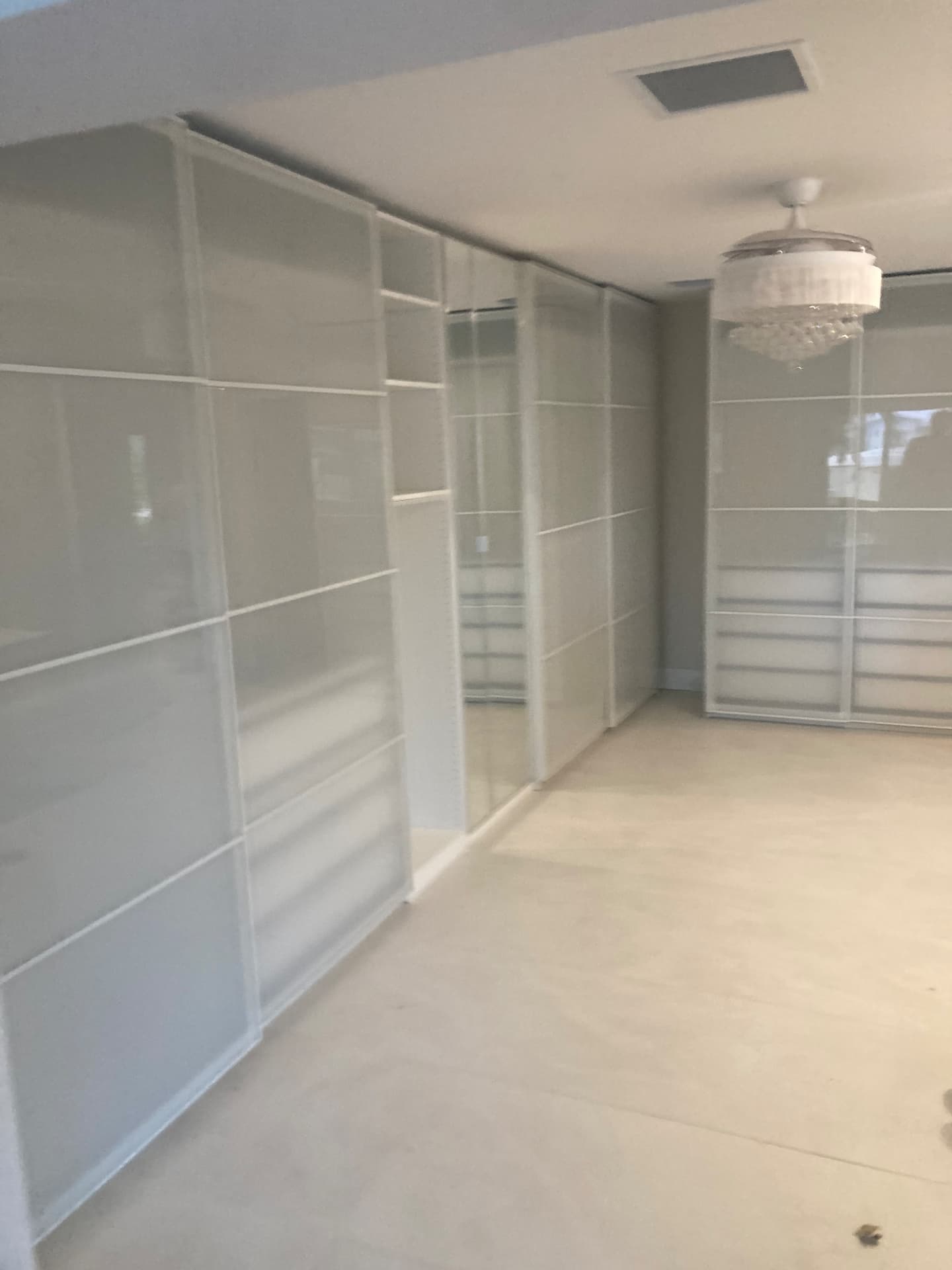 Wall of white sliding-door wardrobe closet systems assembled and installed in Wellington